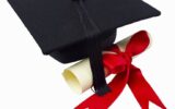 Close up of a graduation cap and a certificate with a ribbon --- Image by © Royalty-Free/Corbis